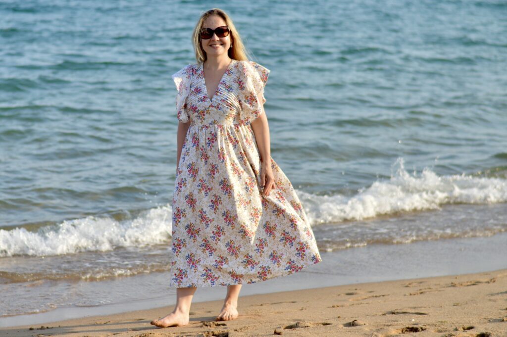 Summer Dresses_girl walking on the beach wearing Nina dress